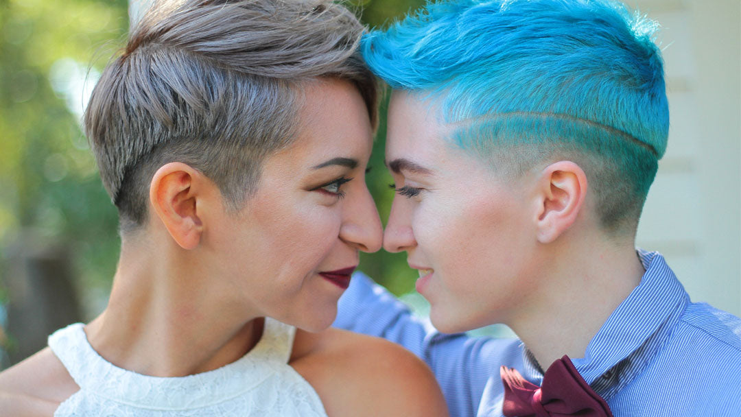 Lesbian genderqueer couple looking into each others eyes