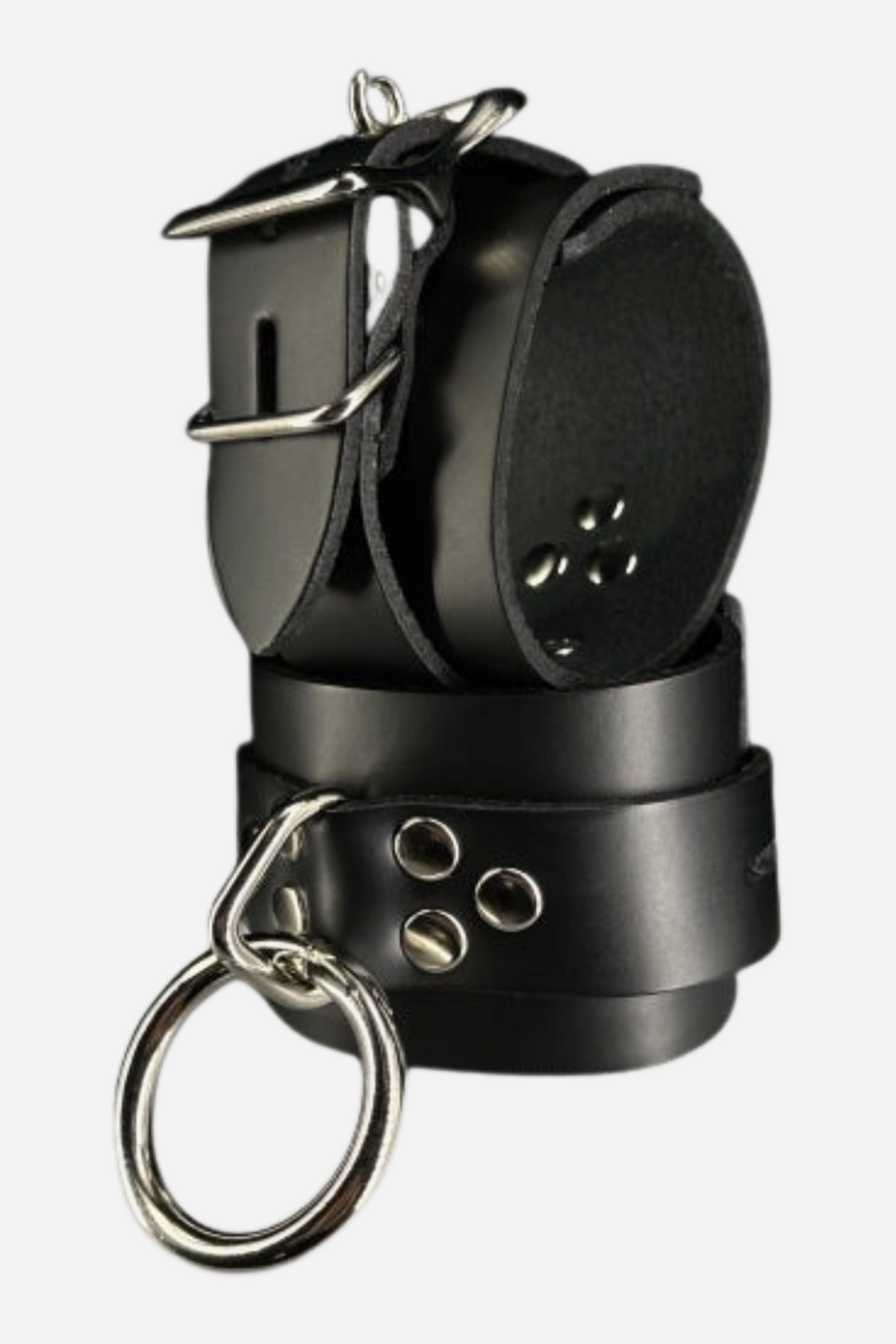 Pair of black unlined leather wrist cuffs stacked together, with a lockable silver buckle, three silver rivets and a large silver O-ring on the front.
