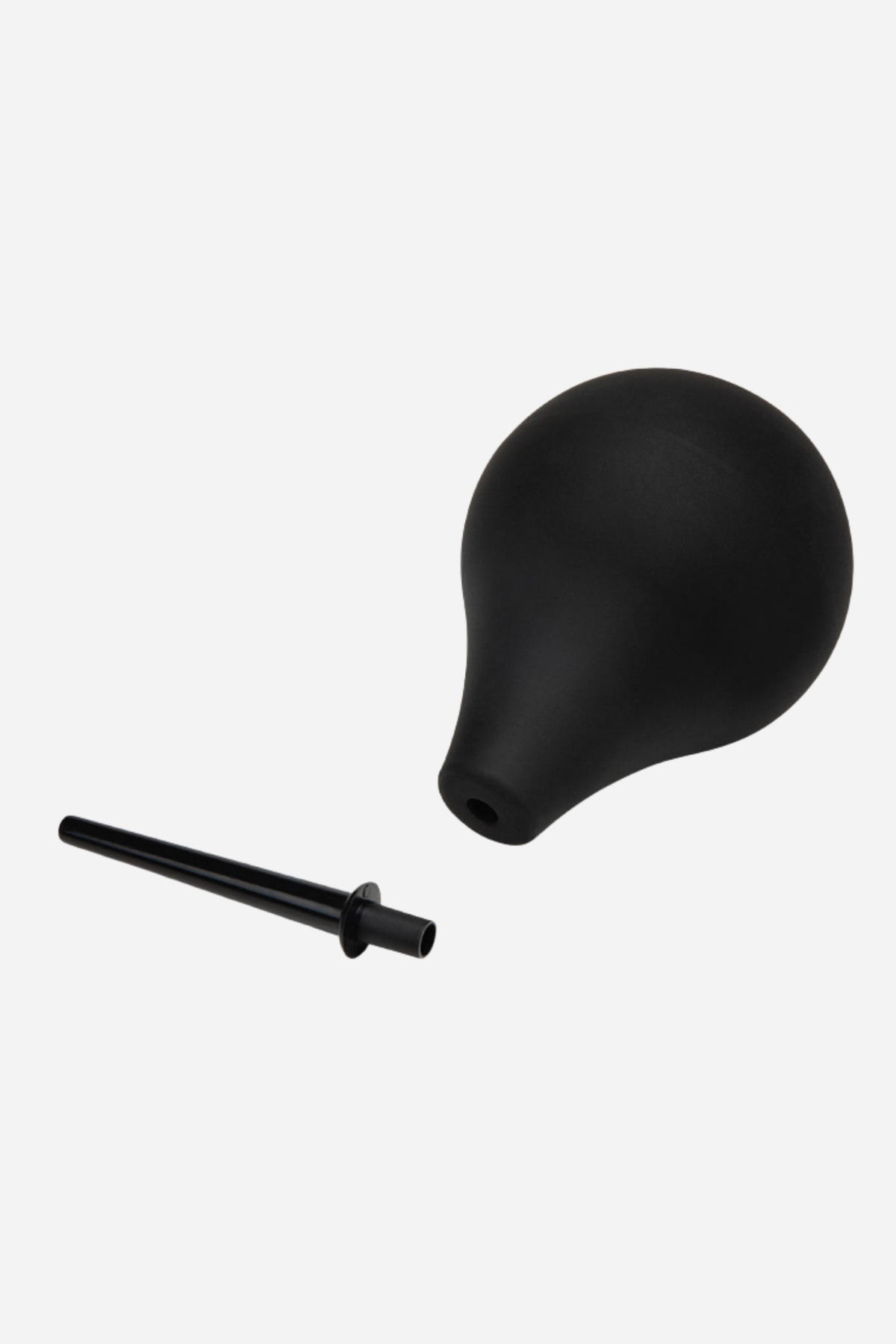 B-Vibe Slimline Classic Enema taken apart on grey, the slim black nozzle lying beside the round squeeze bulb to show the open bulb neck.