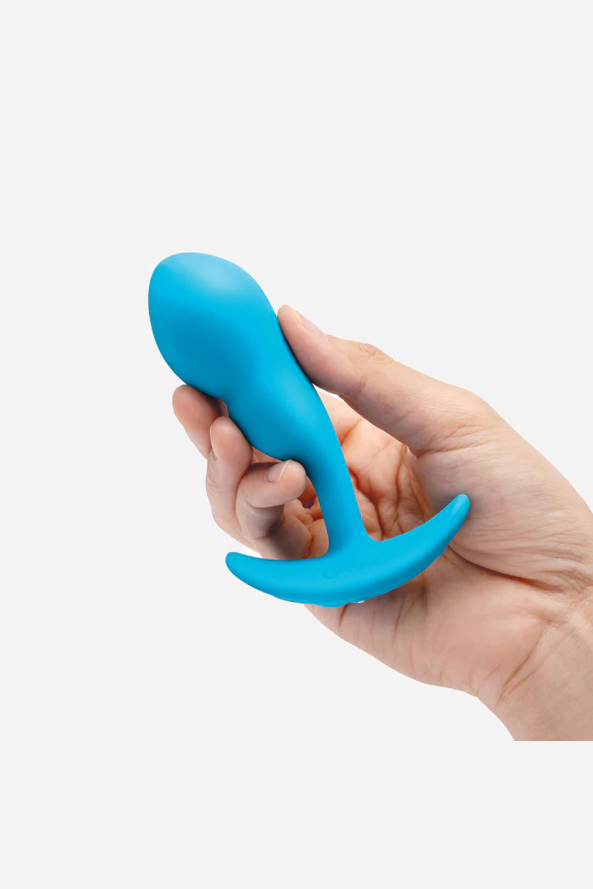A hand cradling the teal plug on its side, showing its length against the fingers