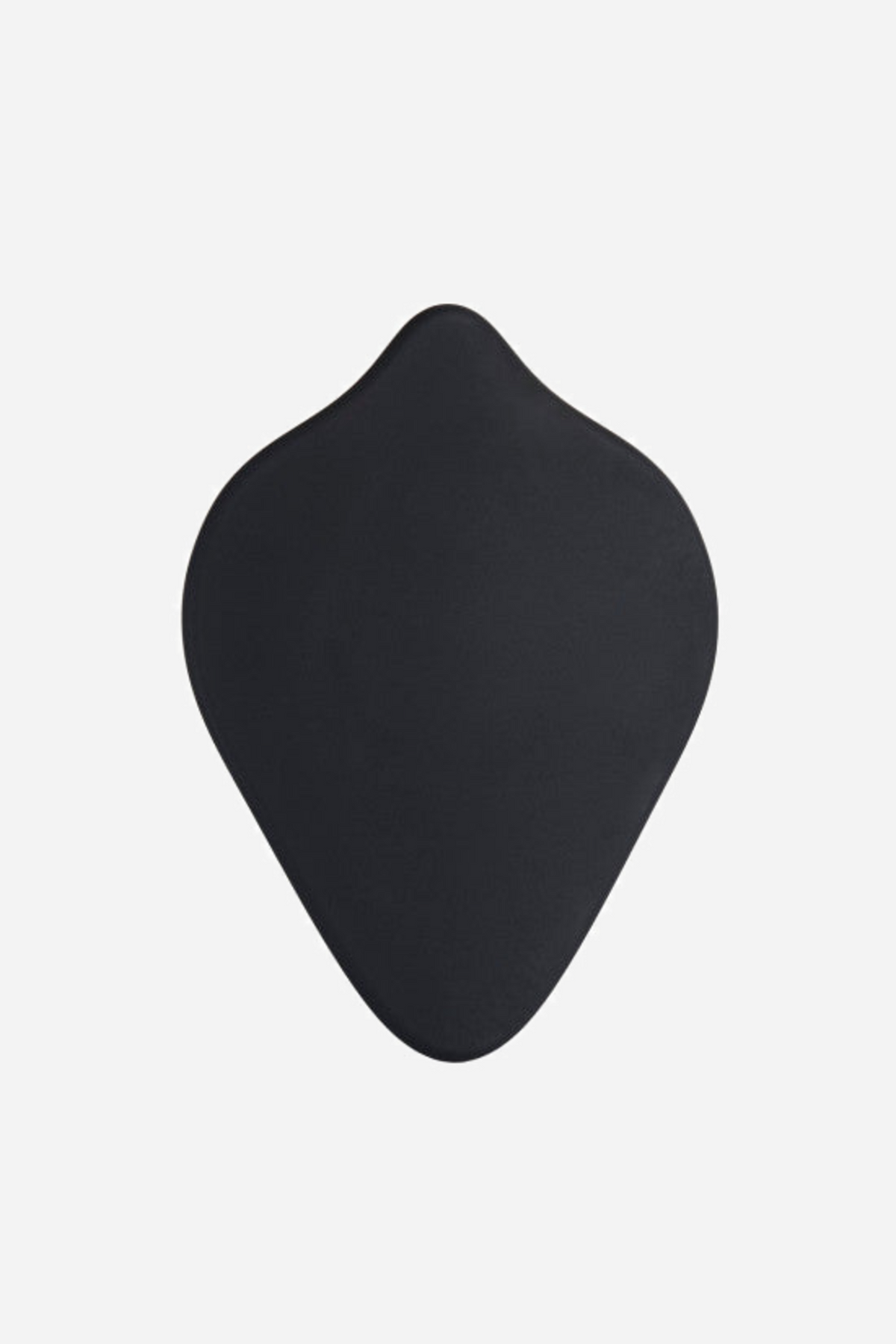 The plain back of the black b.cush pad, showing the smooth teardrop shape that rests against a harness or against the body itself