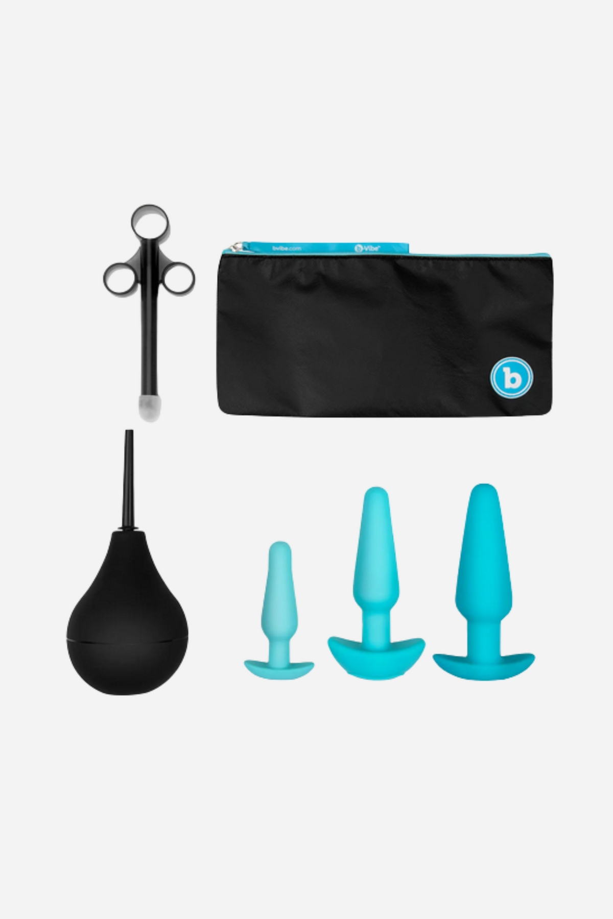 B-Vibe anal training plug set in Turquoise laid out with its enema bulb, lube applicator and travel pouch on light grey