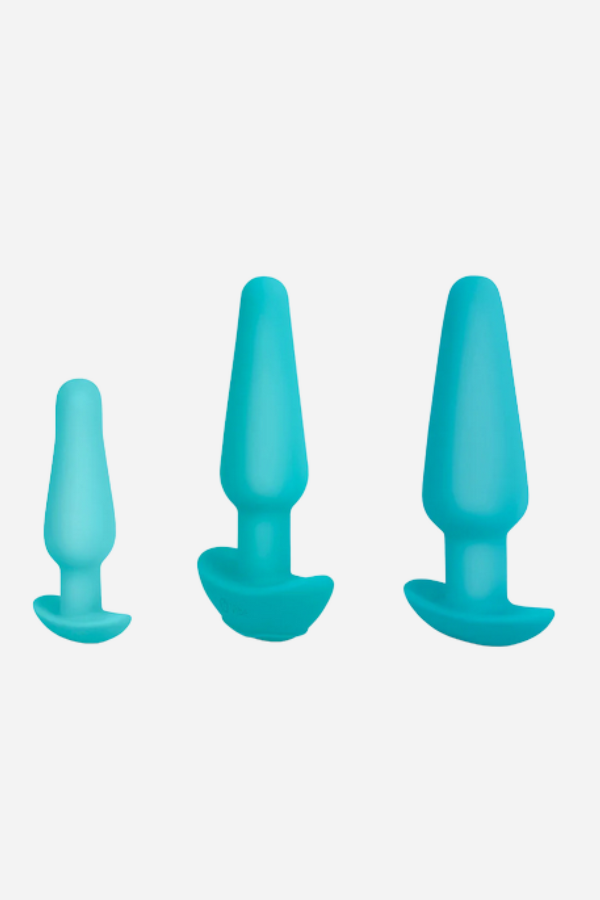 B-Vibe anal training plug set in Turquoise, showing the three graduated small, medium and large silicone plugs on grey