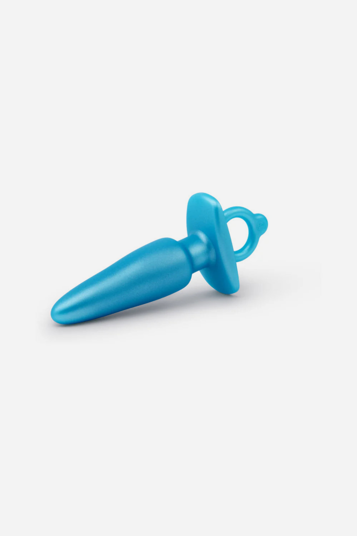 Side view of the blue B-Vibe Butties sleek tapered plug, showing the smooth tapered silicone shaft and finger ring base, on grey