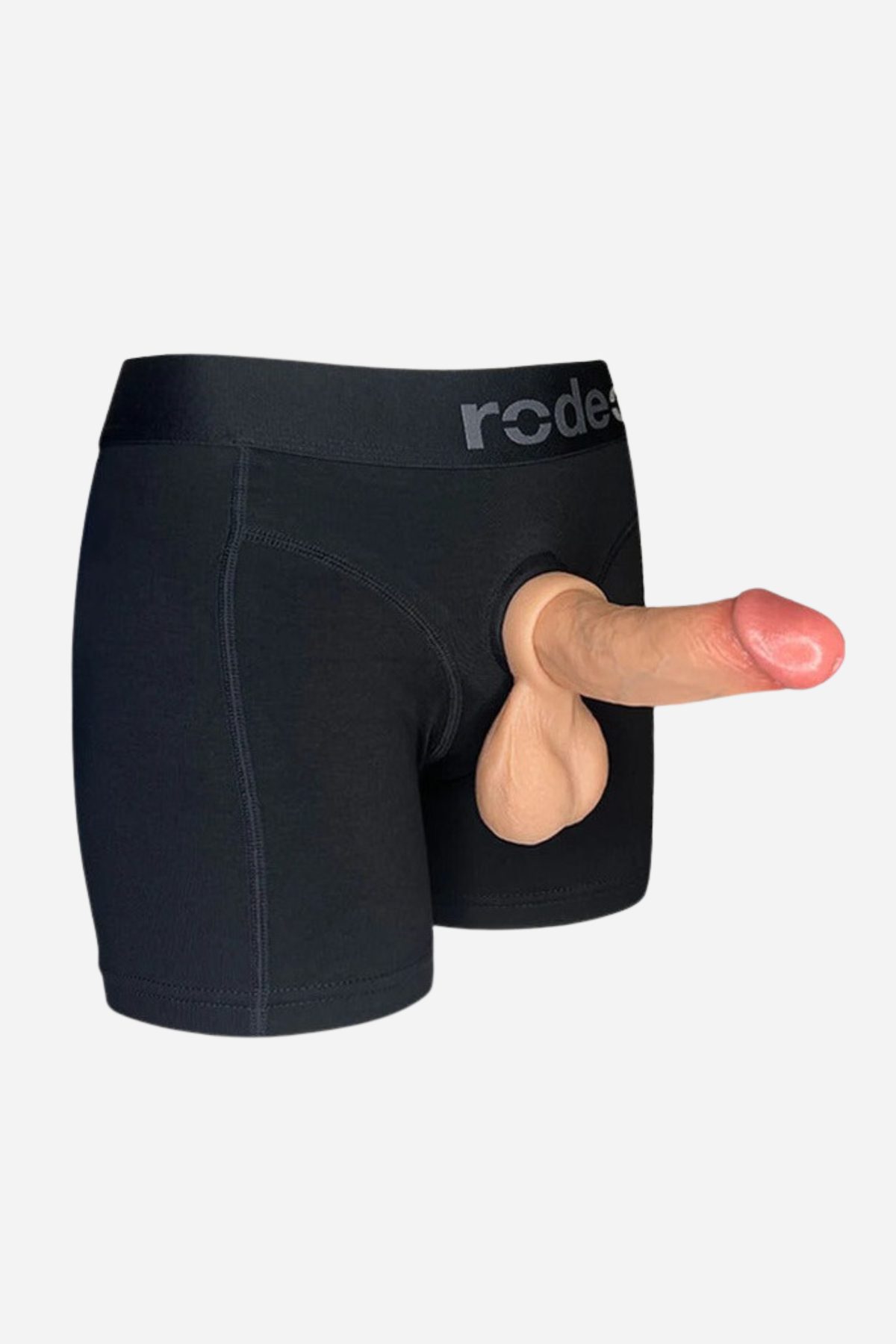 Ball Bump attachment cock ring in Caramel worn with a packer through black boxer briefs, showing how it sits, on a light grey background
