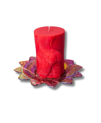 red round pillar wax play candle with imprint of a booty on the side of the candle.