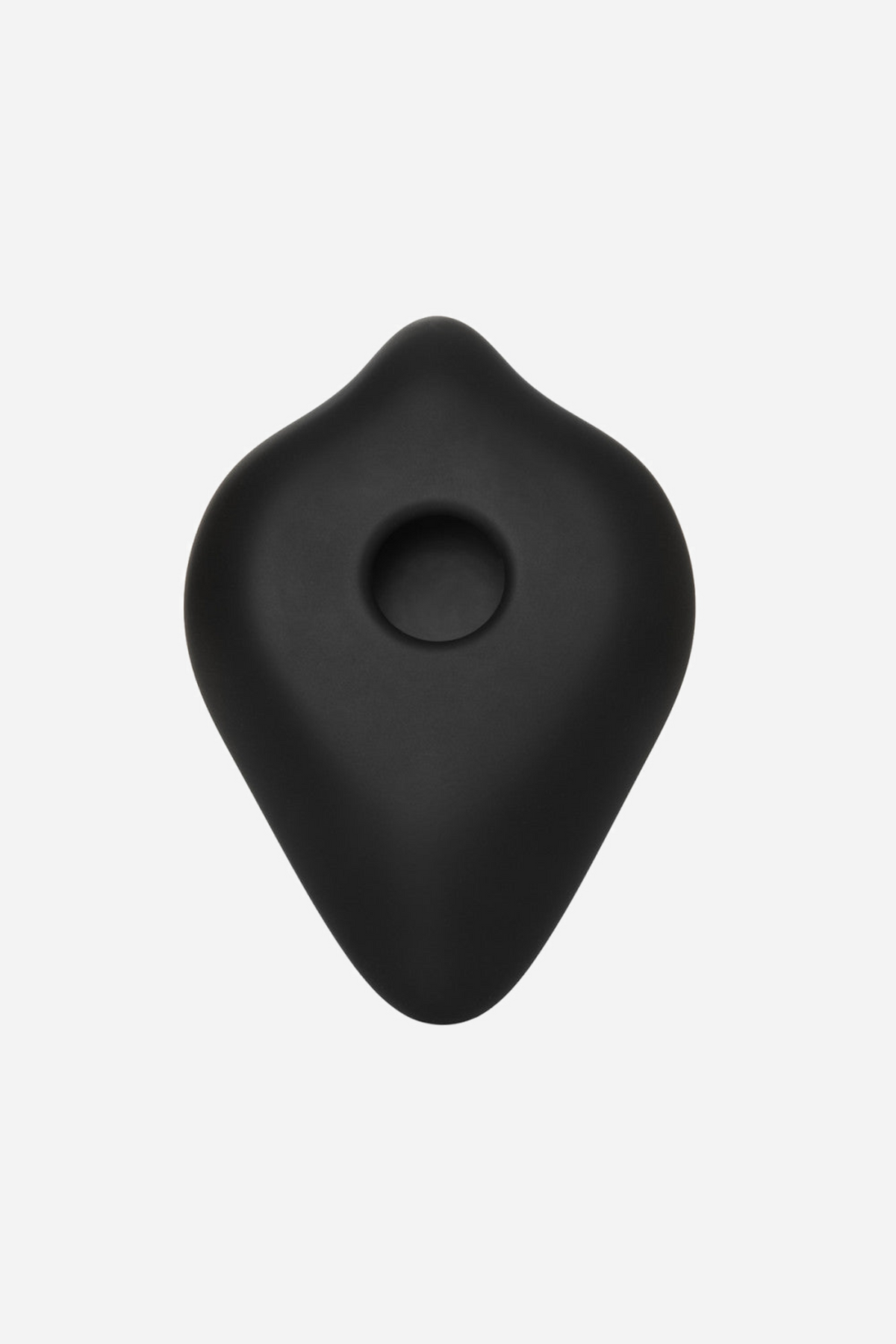 Back of the black BumpHer pad, showing the flat rear face and the round central hole the base of a dildo is pushed through to fit.