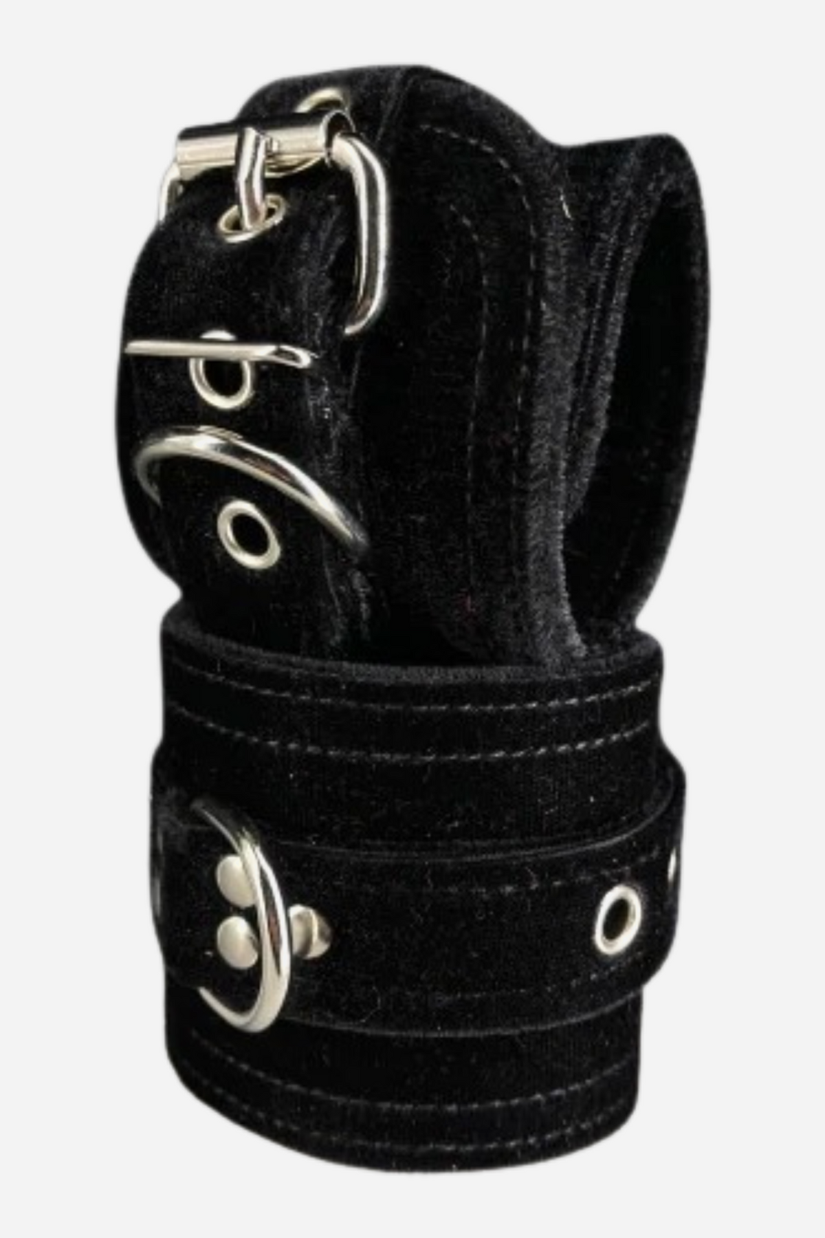 Pair of wide black velvet restraint cuffs stacked together, with white stitched edges, silver roller buckles, grommets and a silver D-ring on each cuff.