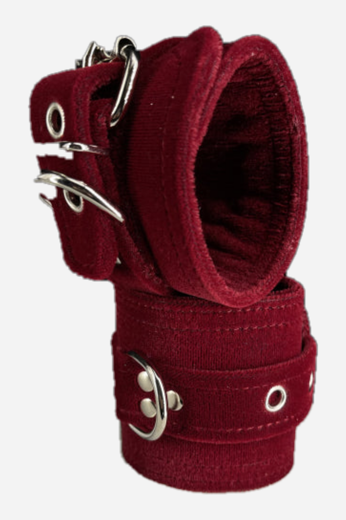 Pair of wide burgundy velvet restraint cuffs stacked together, with silver roller buckles, grommets and a silver D-ring stitched onto each cuff.