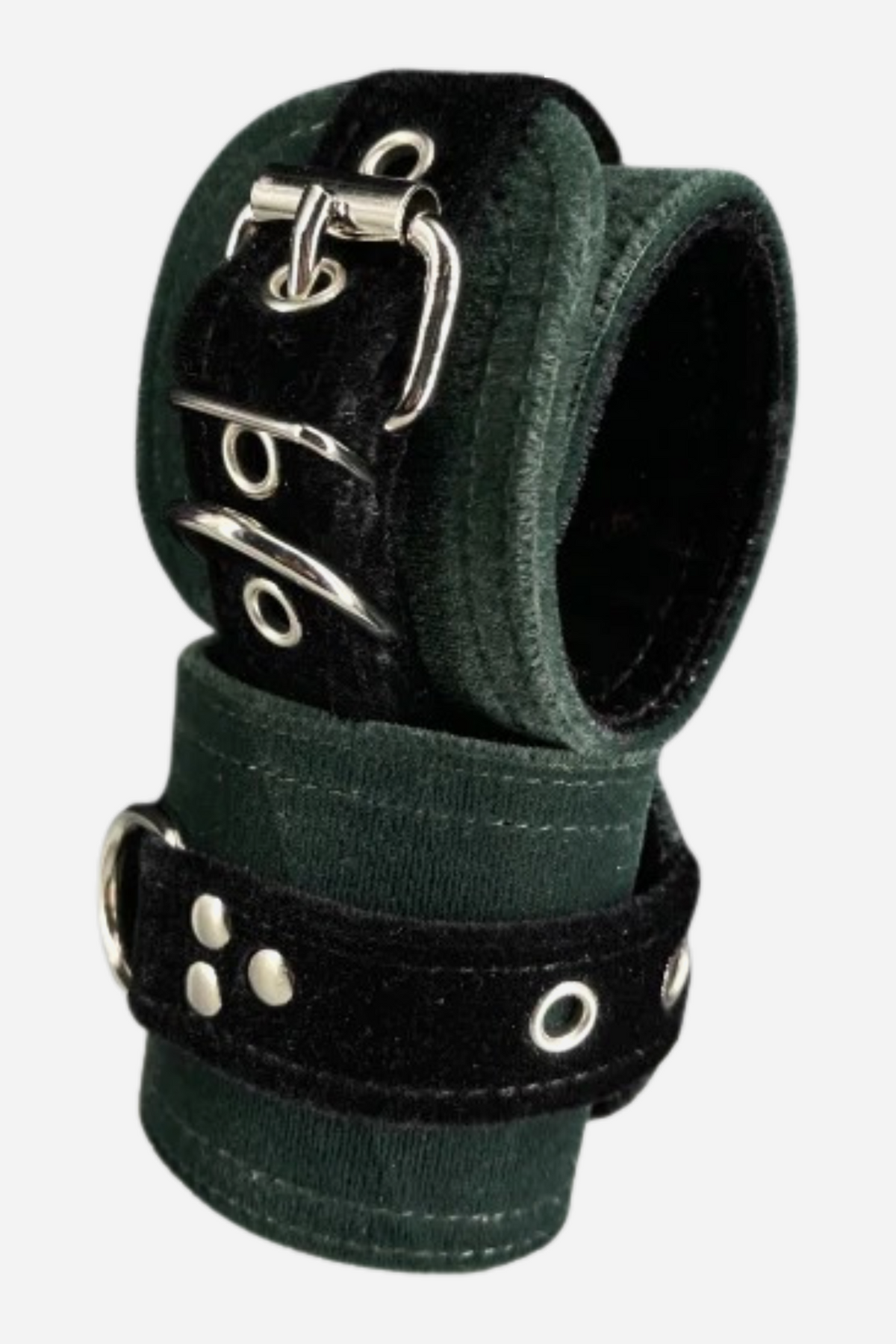 Pair of wide dark green velvet restraint cuffs stacked together, with black velvet straps, silver roller buckles, rivets and a silver D-ring on each.