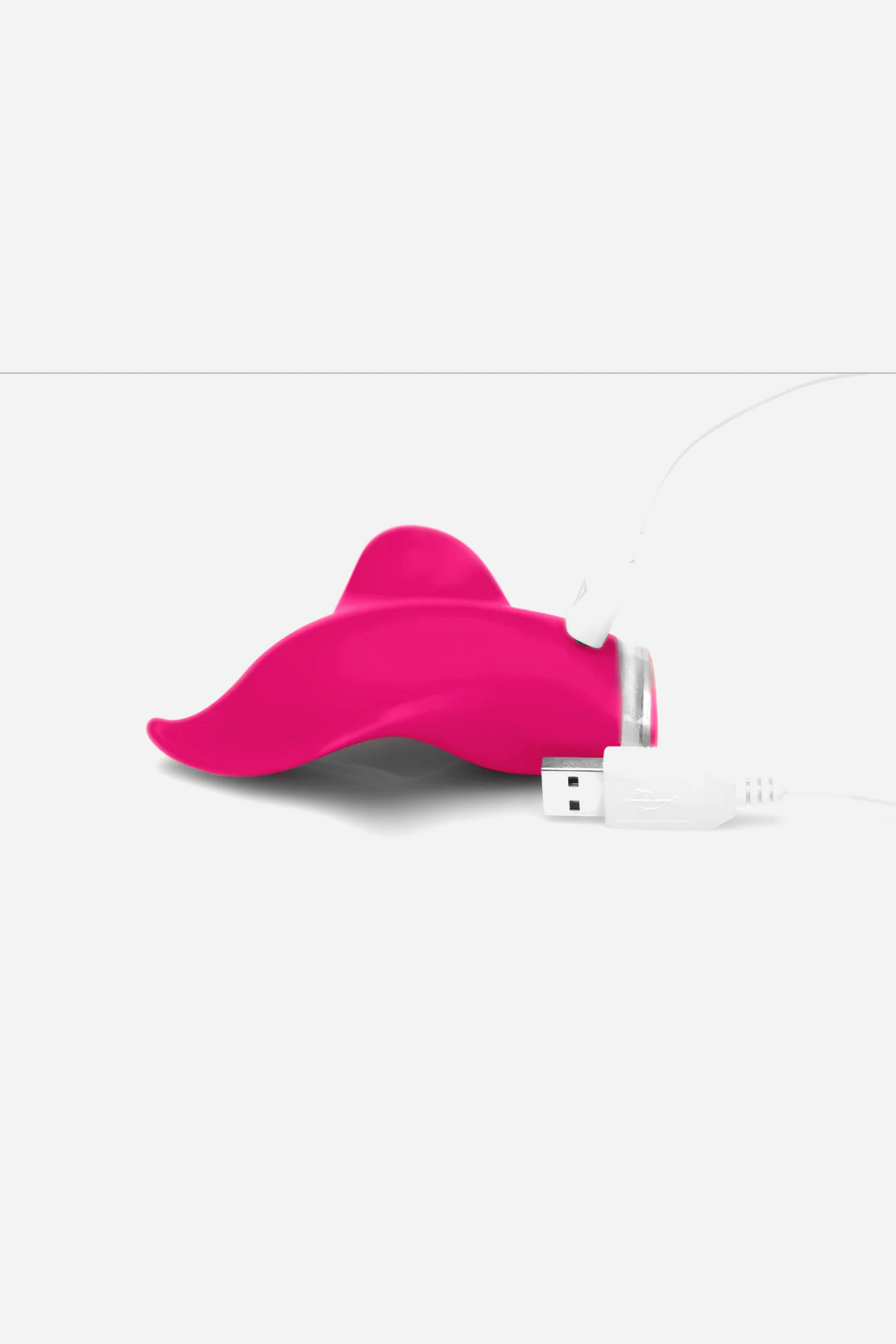 The pink Mimic Plus connected to its white USB magnetic charging cable