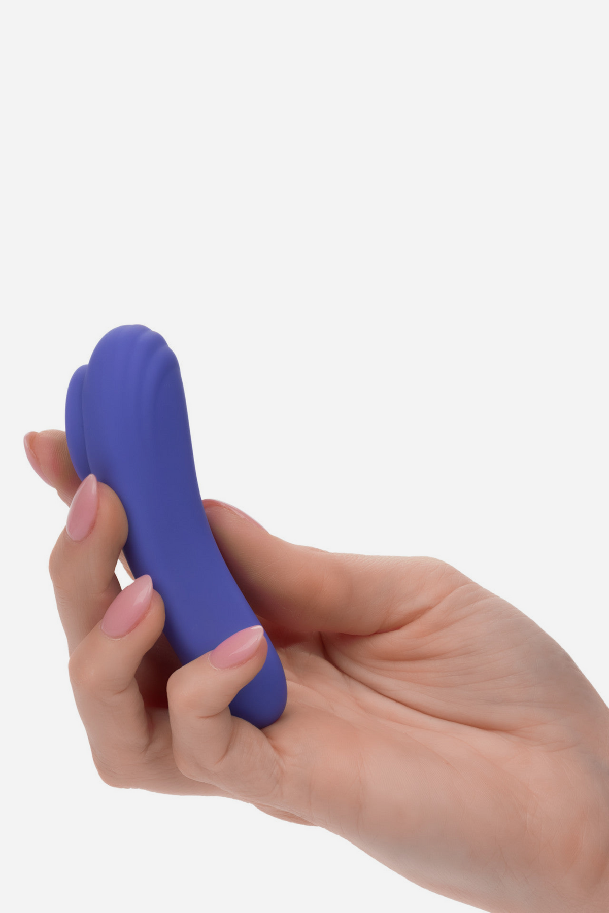 Hand holding the periwinkle Connect Us Wearable Panty Vibe between the fingers, showing its compact palm-sized curved silicone body