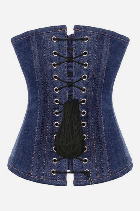 Back of the Cowbae Carter denim overbust corset showing black laces crossed through two rows of silver grommets with the lace ties hanging down