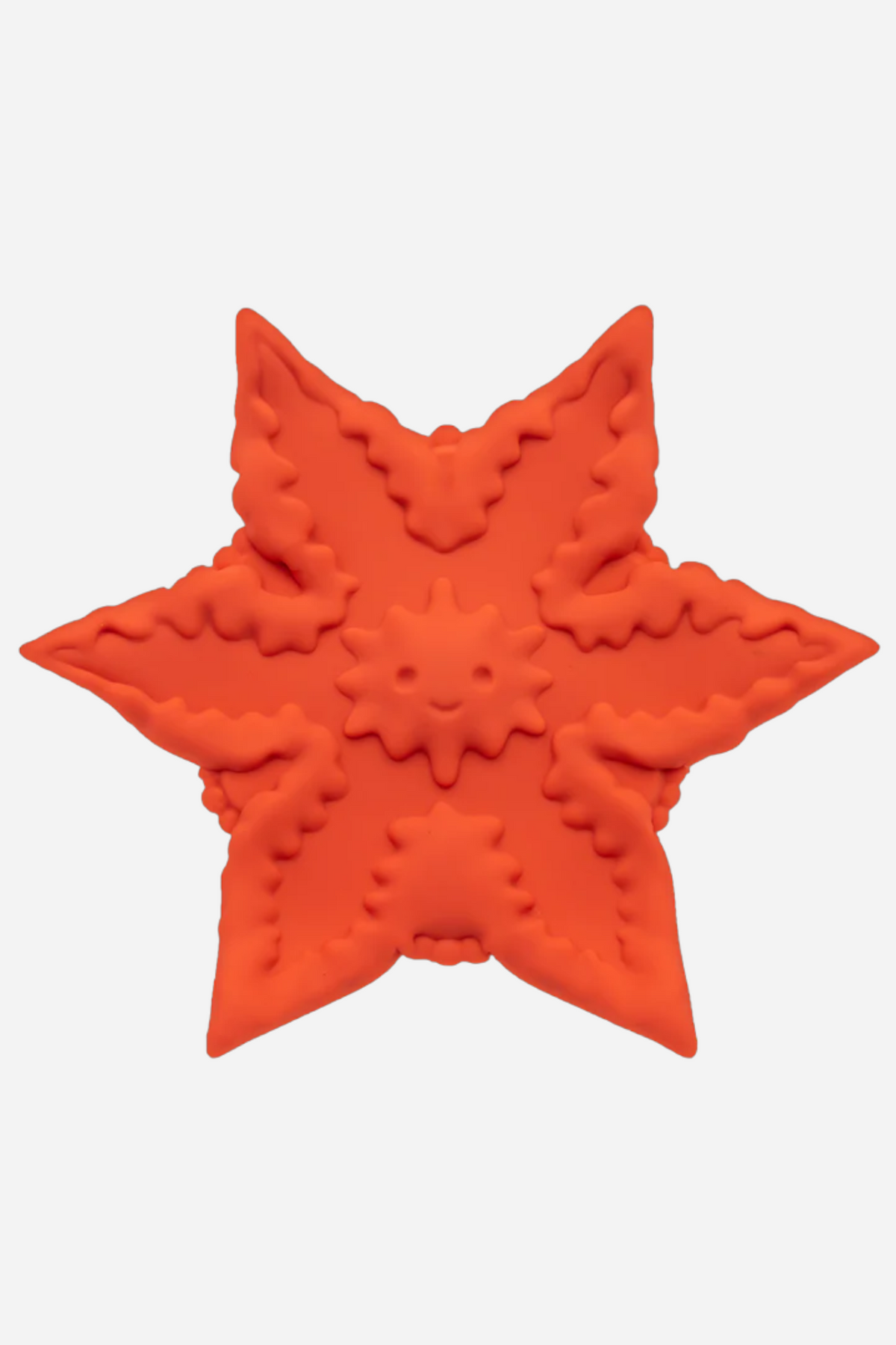 Coral Cute Little Fuckers Starsi vibe, a star shaped textured silicone clitoral vibrator with raised ridges and dots, on grey