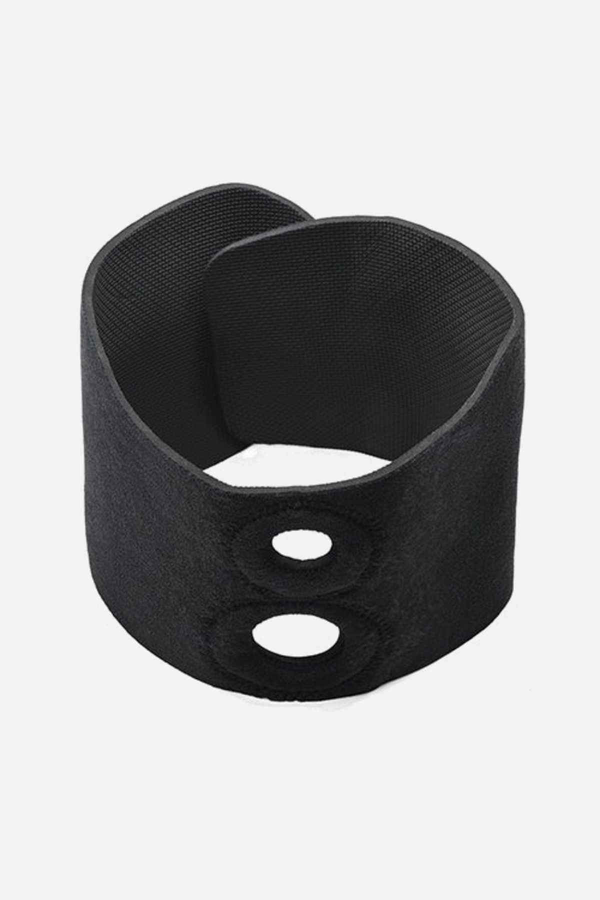 Black Dual Penetration Thigh Harness on grey, a wide hook-and-loop thigh band curled into a loop with two stacked reinforced O-ring openings.