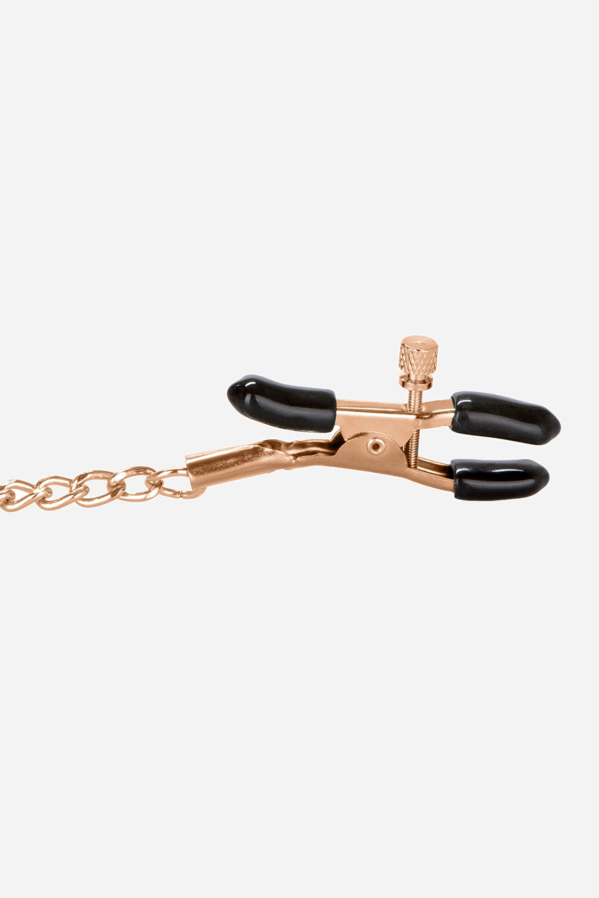 Close view of one rose gold nipple clamp, showing the adjustment screw, the soft black rubber tips and the heavy chain link attached.
