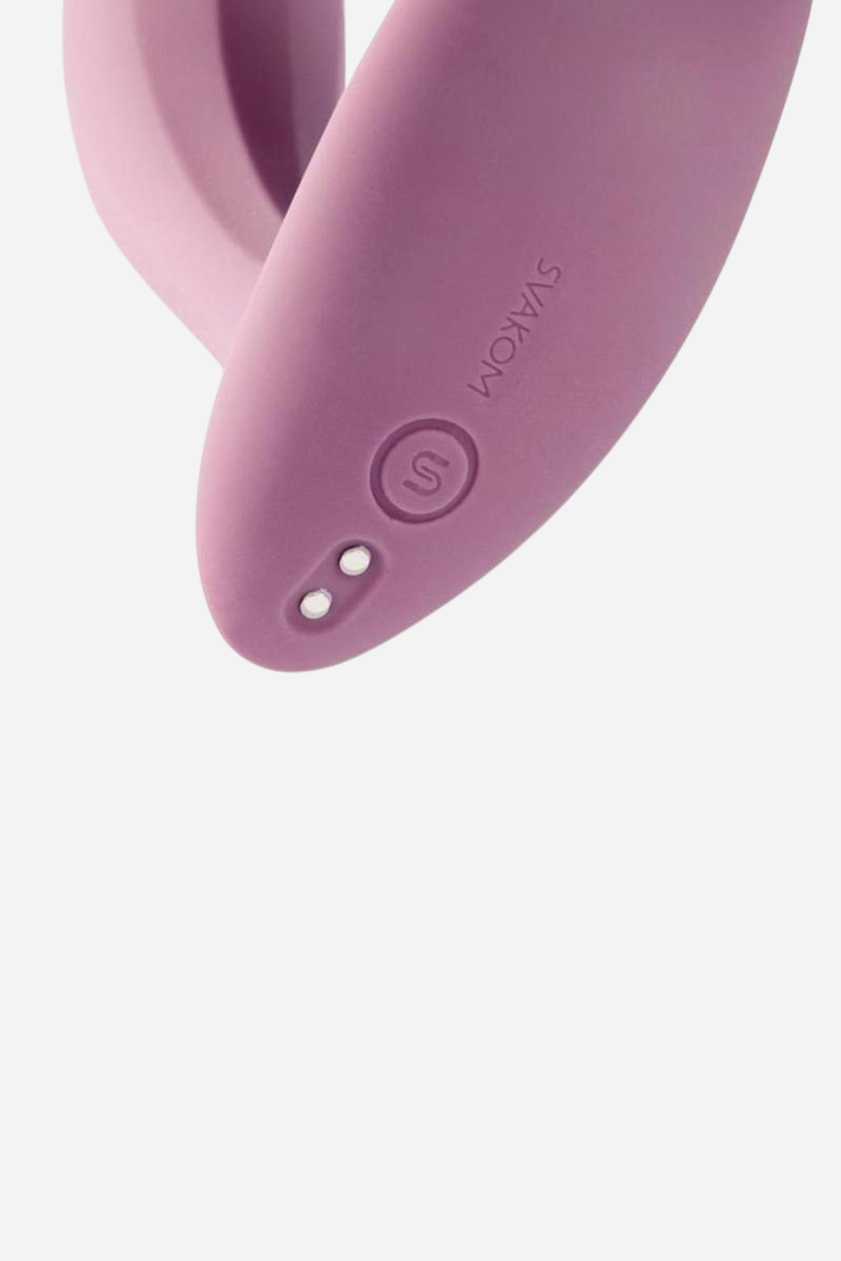 Close crop of the dusty pink Erica vibe, showing the rounded control button and charging contacts set into its smooth silicone arm.