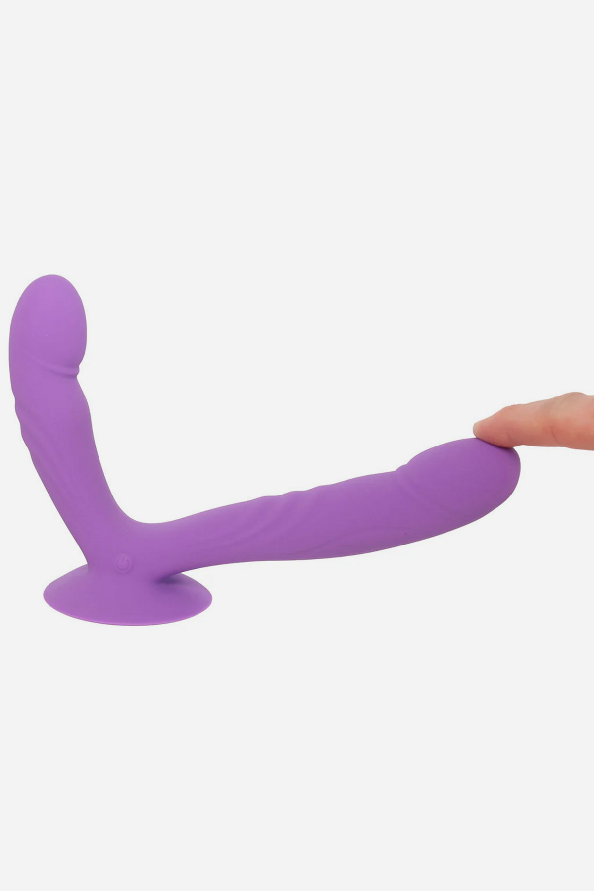 Hand pressing the tip of the Get In Ya Dual Dildo as it lies on its suction cup, showing how flexible the silicone shafts are