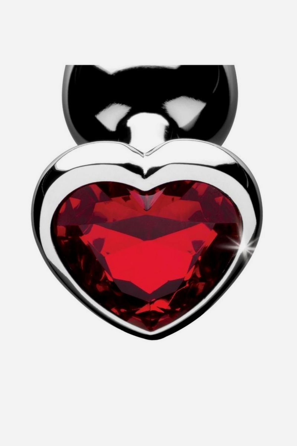 Close-up of the faceted red heart-shaped gem set into the polished silver base of the Heart Sparks Butt Plug, catching the light