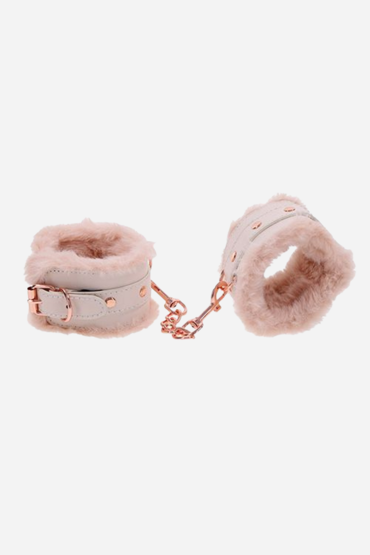 The pair of fur-lined cuffs fastened closed and set side by side, joined by a short rose gold chain, against a plain grey backdrop.