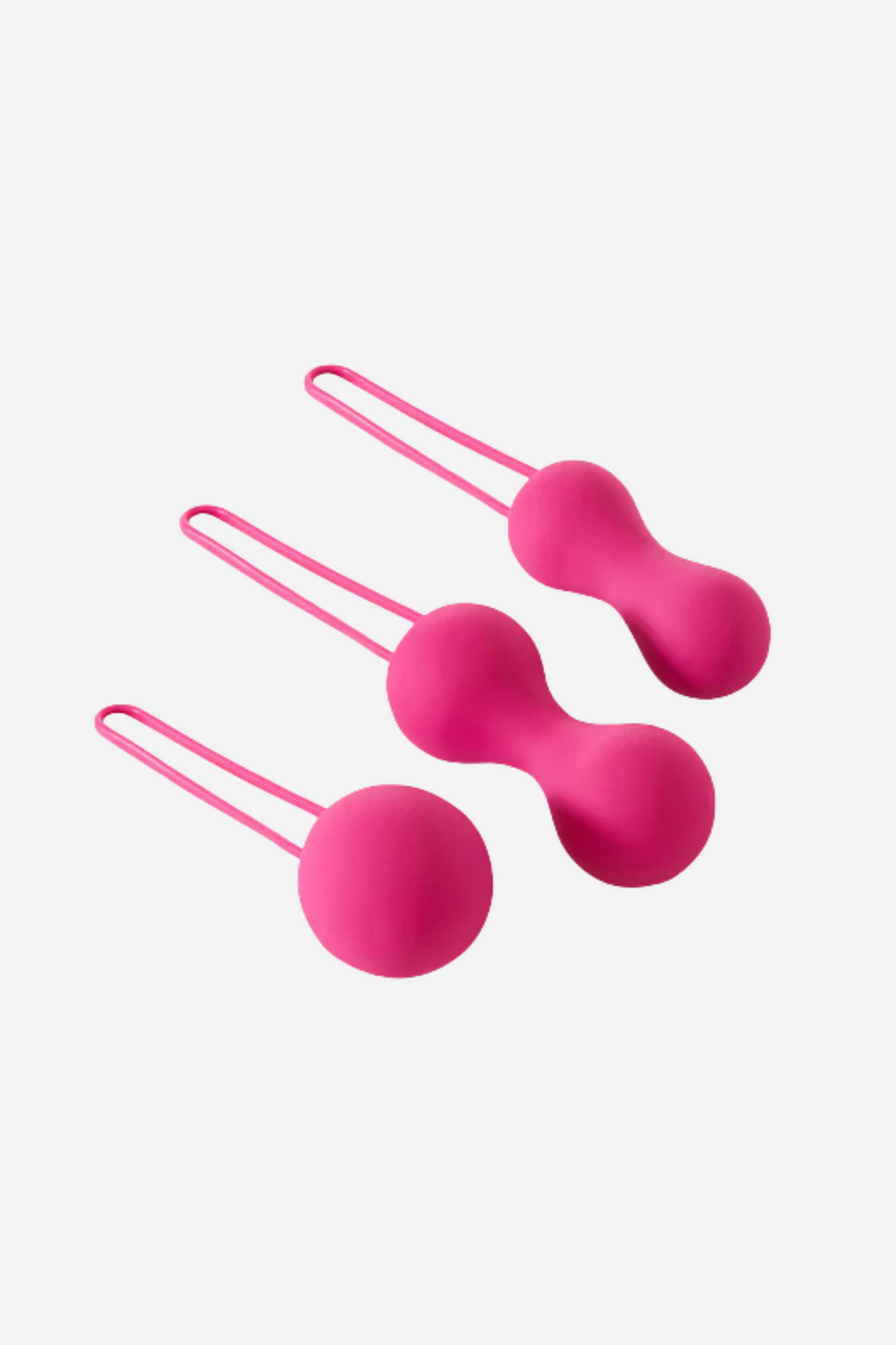 Fuchsia Je Joue Ami kegel balls laid at an angle, showing the smooth silicone weights and the flexible retrieval loops, on grey