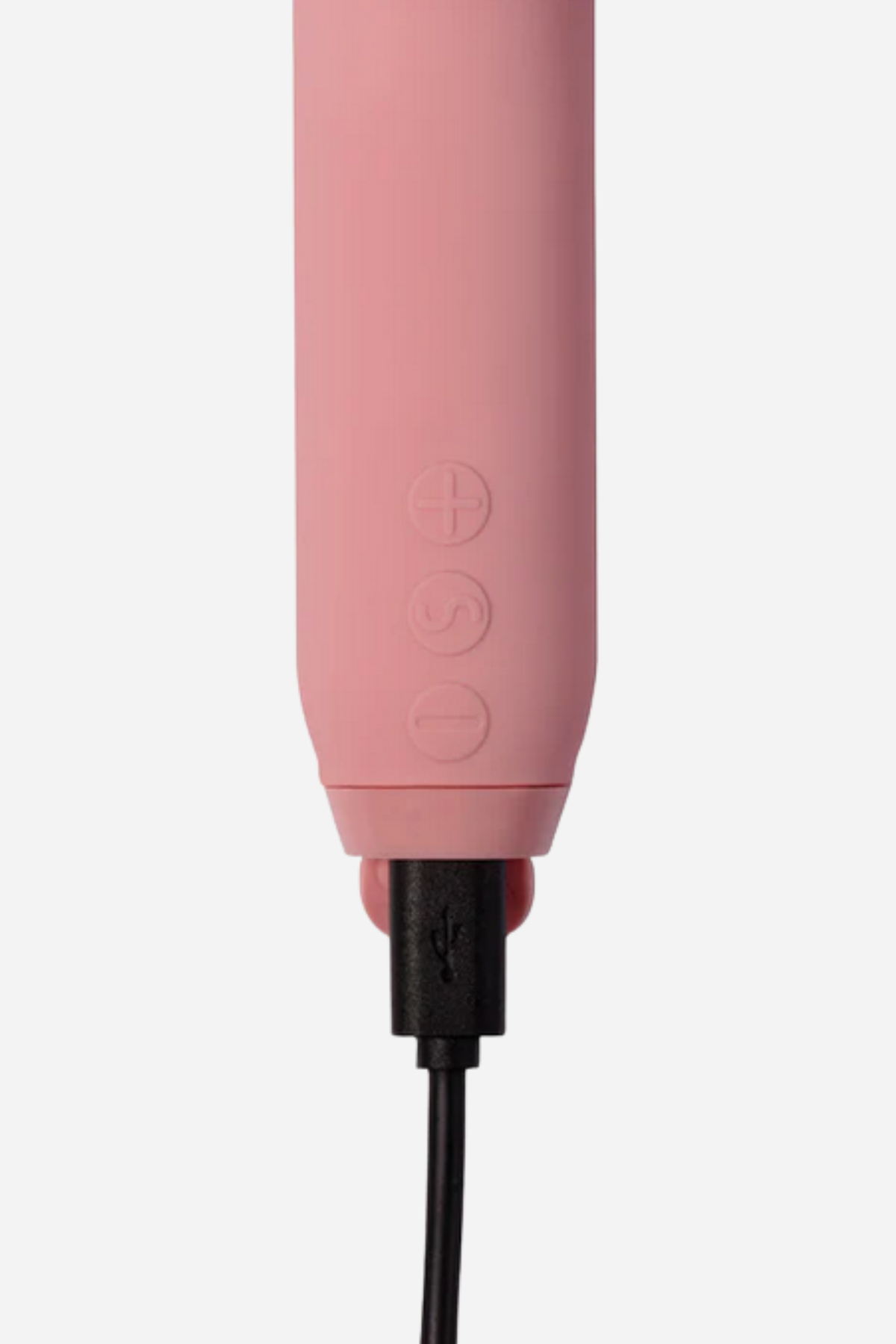 Close up of the base of the rose Amour bullet on grey with its black magnetic charging cable attached to the flat contact end.