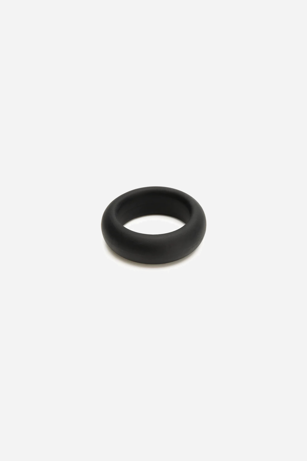 Black silicone C-ring resting flat at a three-quarter angle, showing its smooth rounded band