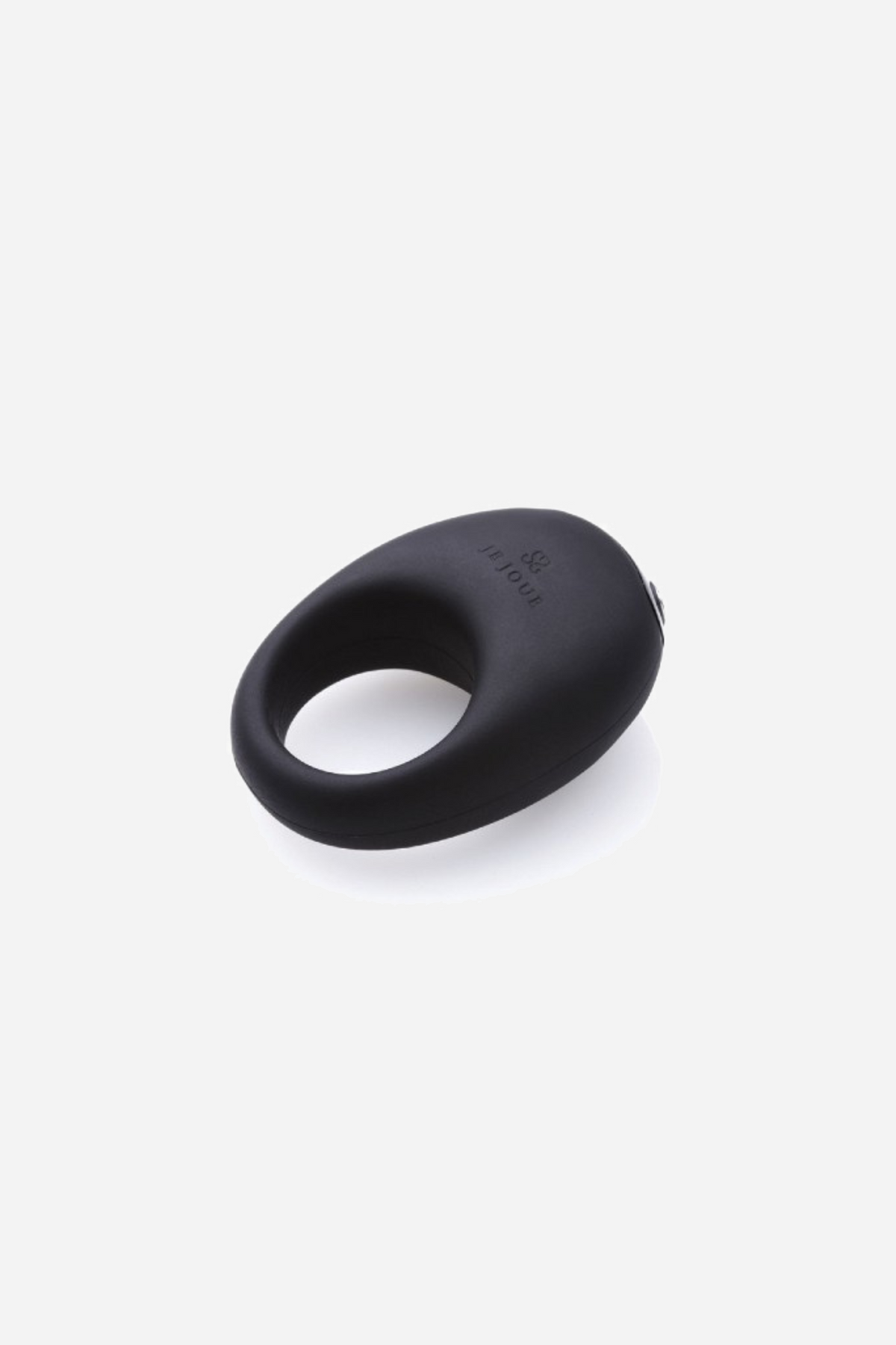 Black Je Joue Mio vibrating cock ring resting flat on a plain grey backdrop, photographed from above as a soft rounded silicone loop.