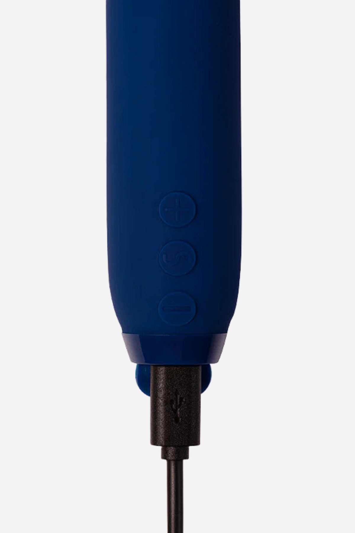 Close-up of the cobalt blue Je Joue Vita Lipped Bullet base with a USB charging cable plugged into the port just below the buttons