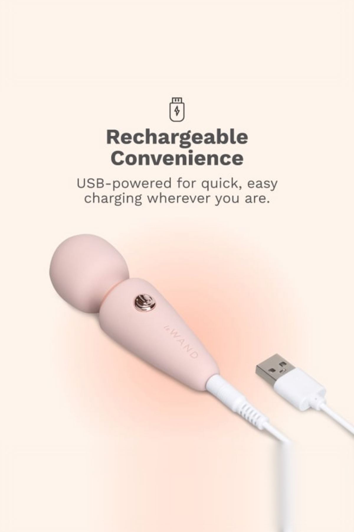 Light pink Le Wand Micro Wand connected to its USB charging cable, highlighting the quick and easy rechargeable convenience