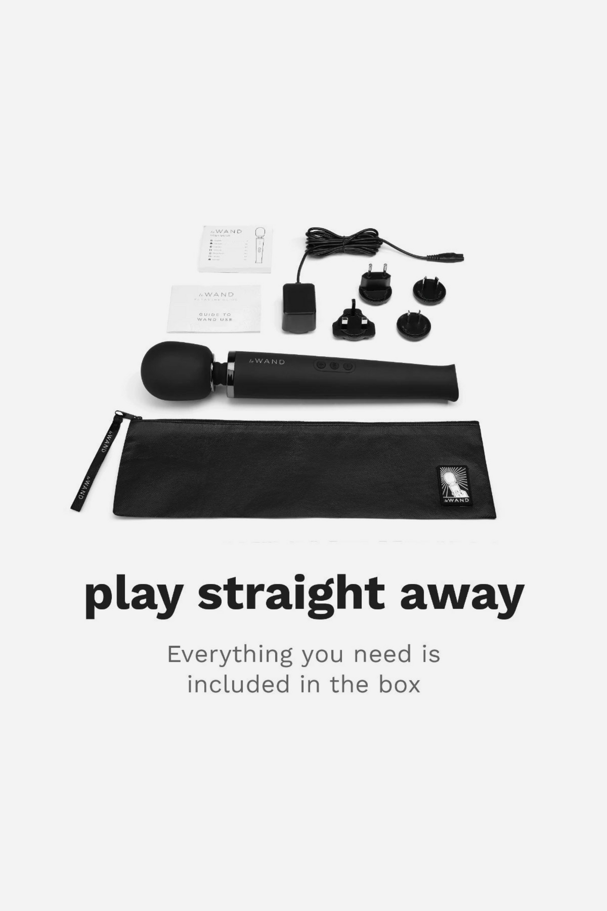 Black Le Wand Original Rechargeable Wand shown with everything in the box, including charger, plug adapters and storage bag, ready to use