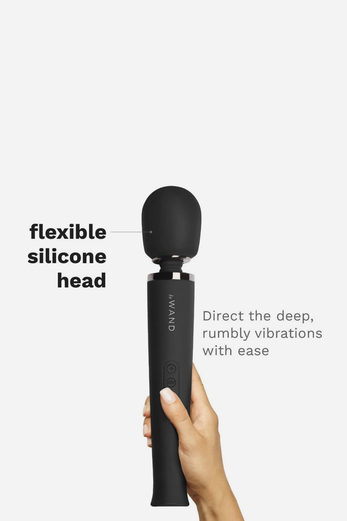 Hand holding the black Le Wand Original Rechargeable Wand upright, highlighting its flexible silicone head for deep, rumbly vibrations
