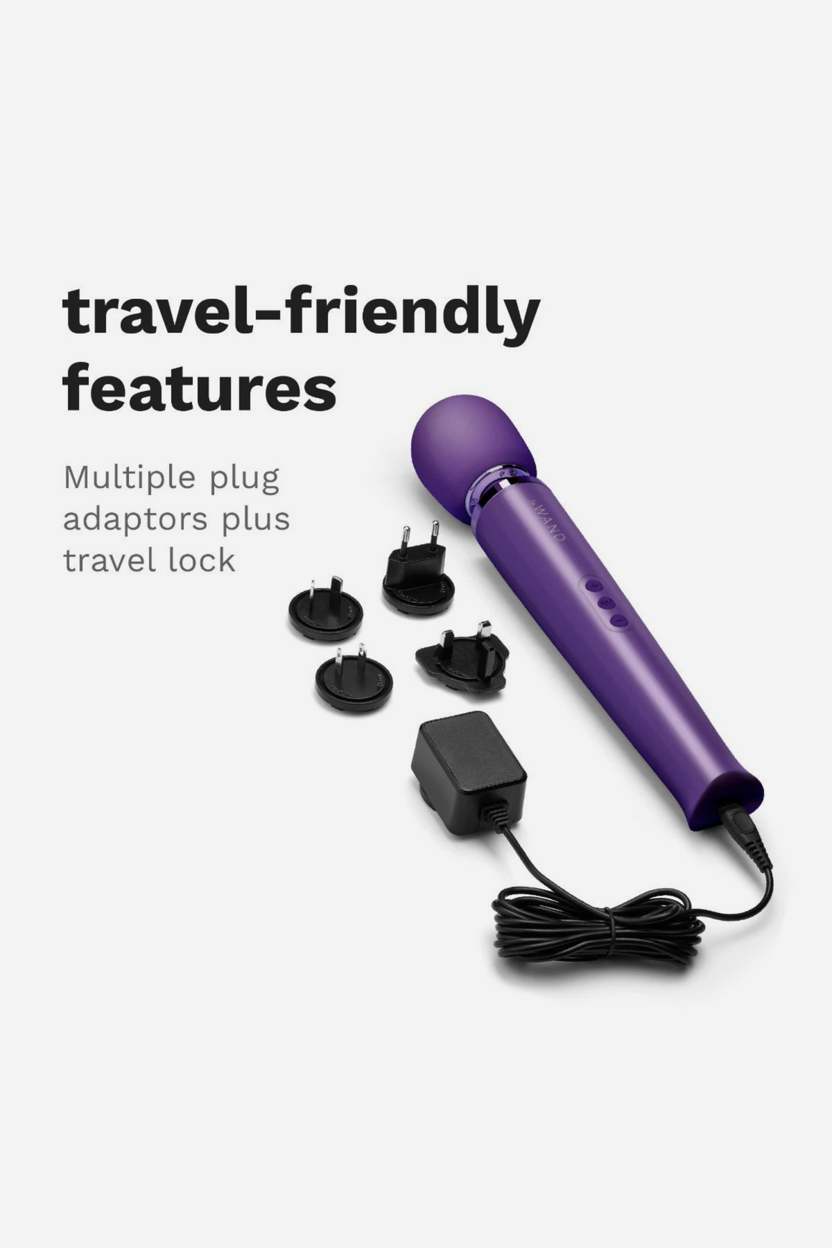 Purple Le Wand Original Rechargeable Wand with its charger and international plug adapters, showing off its travel-friendly features