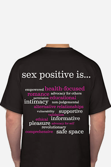 Back of the black Lotus Blooms T-shirt printed with sex positive is... and a word cloud in white and pink like intimacy and safe space