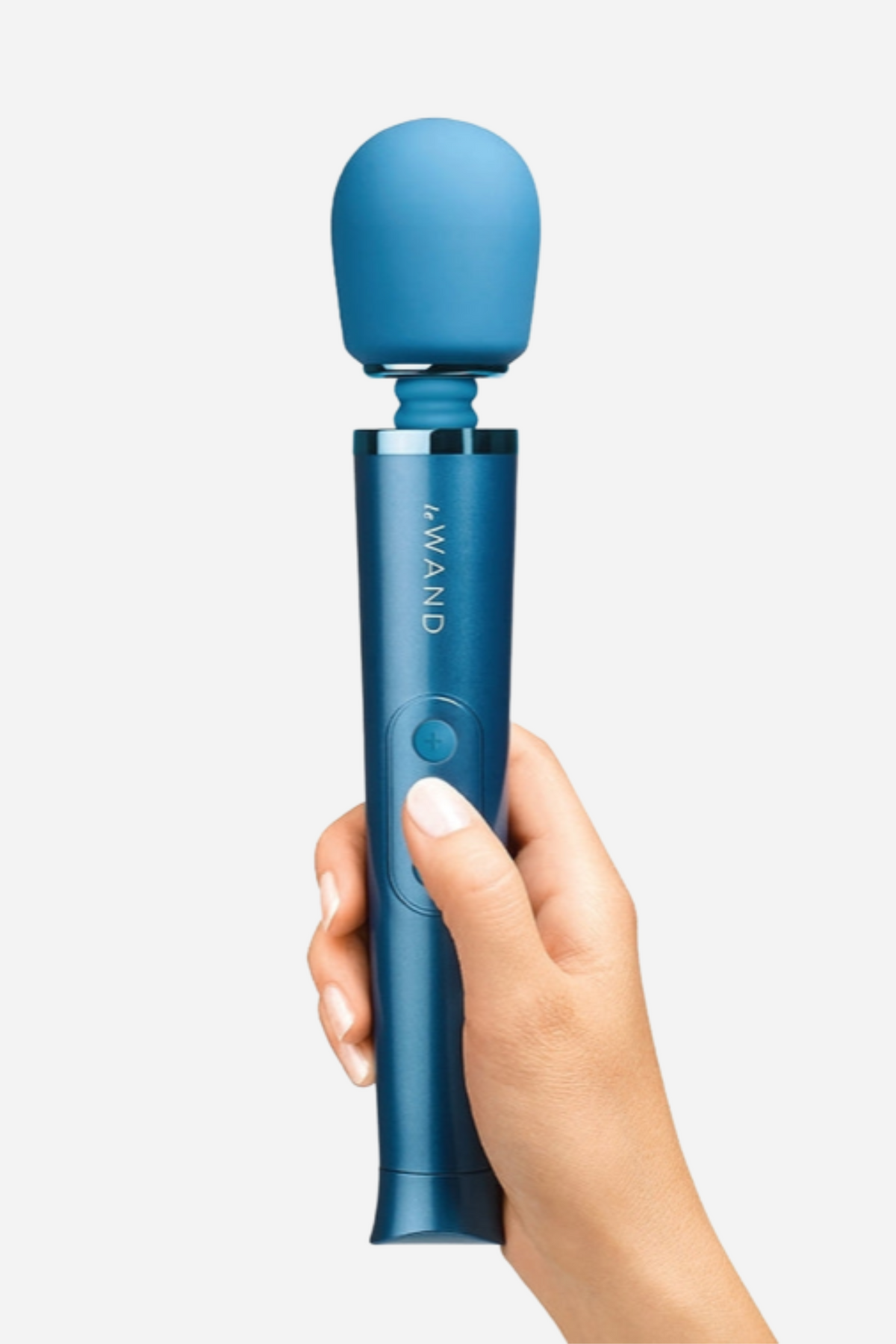 Hand holding the Le Wand Petite massager in blue ice, showing the rounded silicone head and the metallic handle with its control buttons