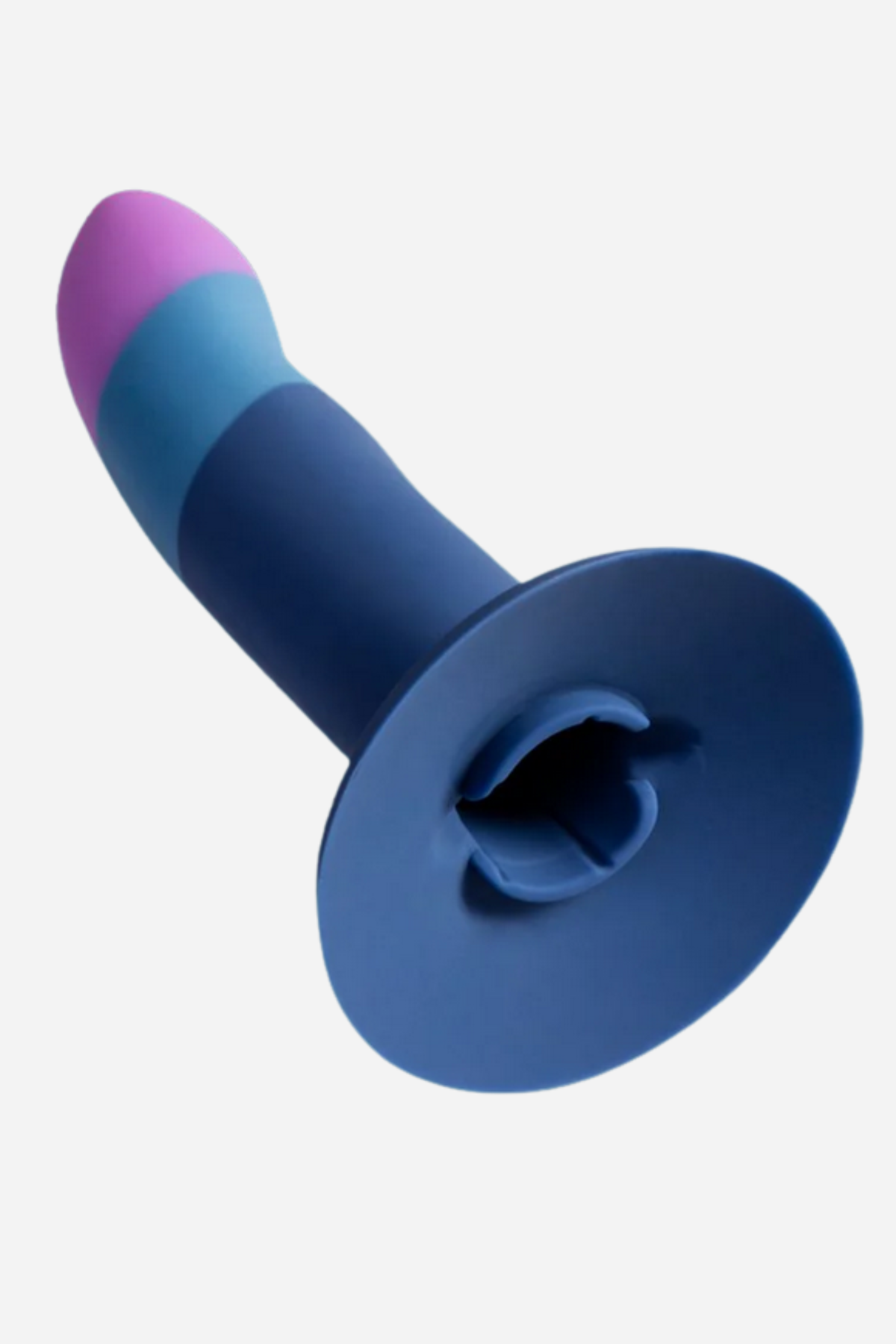 Piccolo pegging dildo in Small angled to show the wide navy suction cup base and curved pink and blue shaft on a light grey background