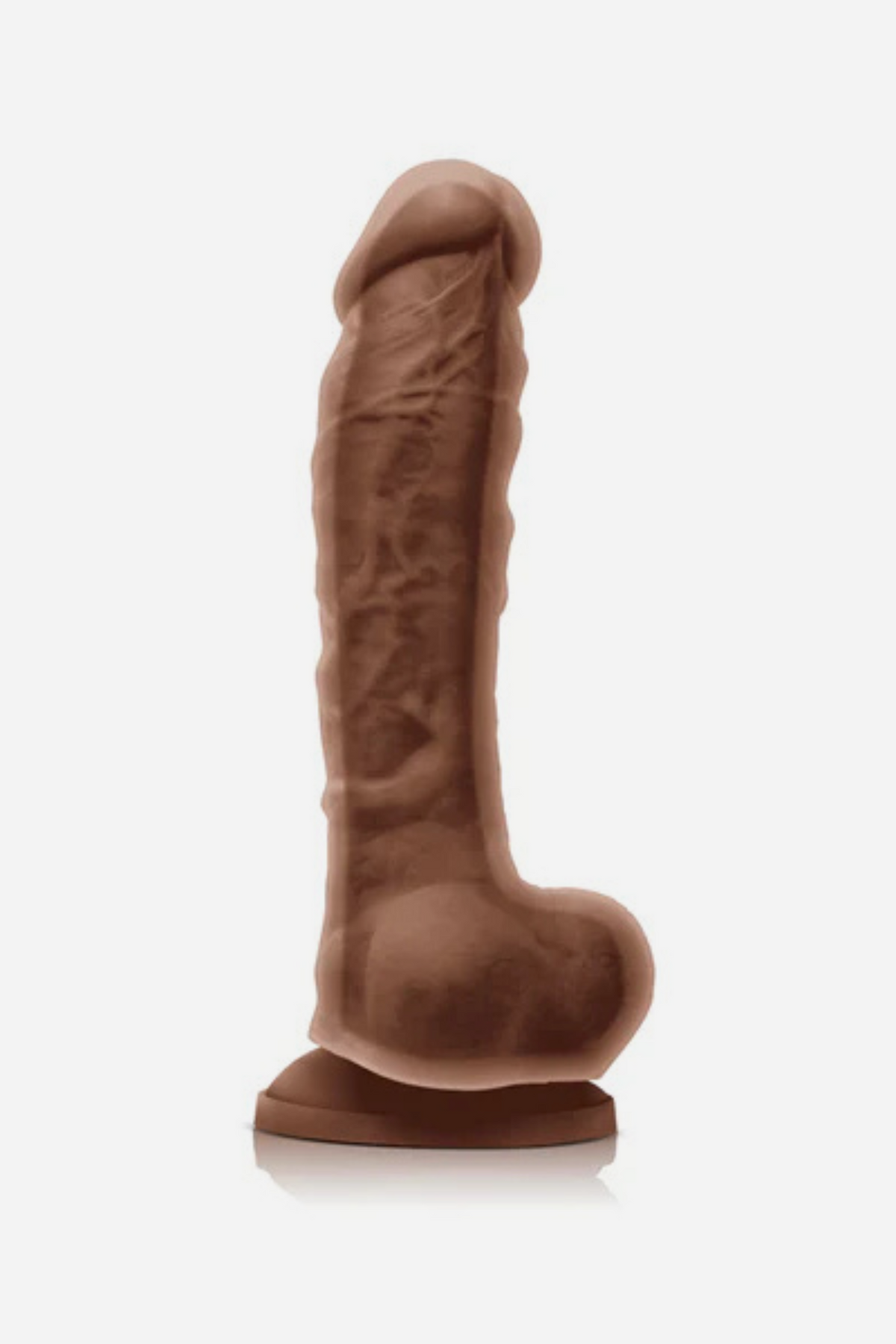 Pleasures 8 inch dual density dildo in caramel skin tone with a firm core, soft lifelike outer layer, veined shaft and suction cup base, on a grey background