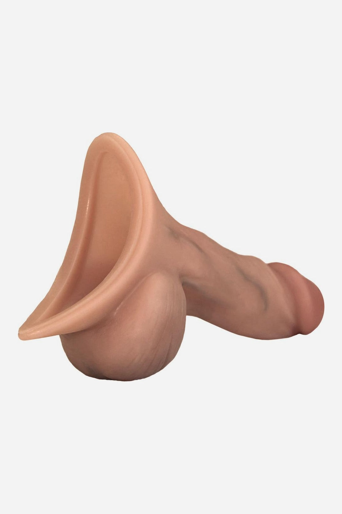 Back angle of the Caramel Realistic STP device showing the wide oval silicone funnel used for standing to pee, on light grey