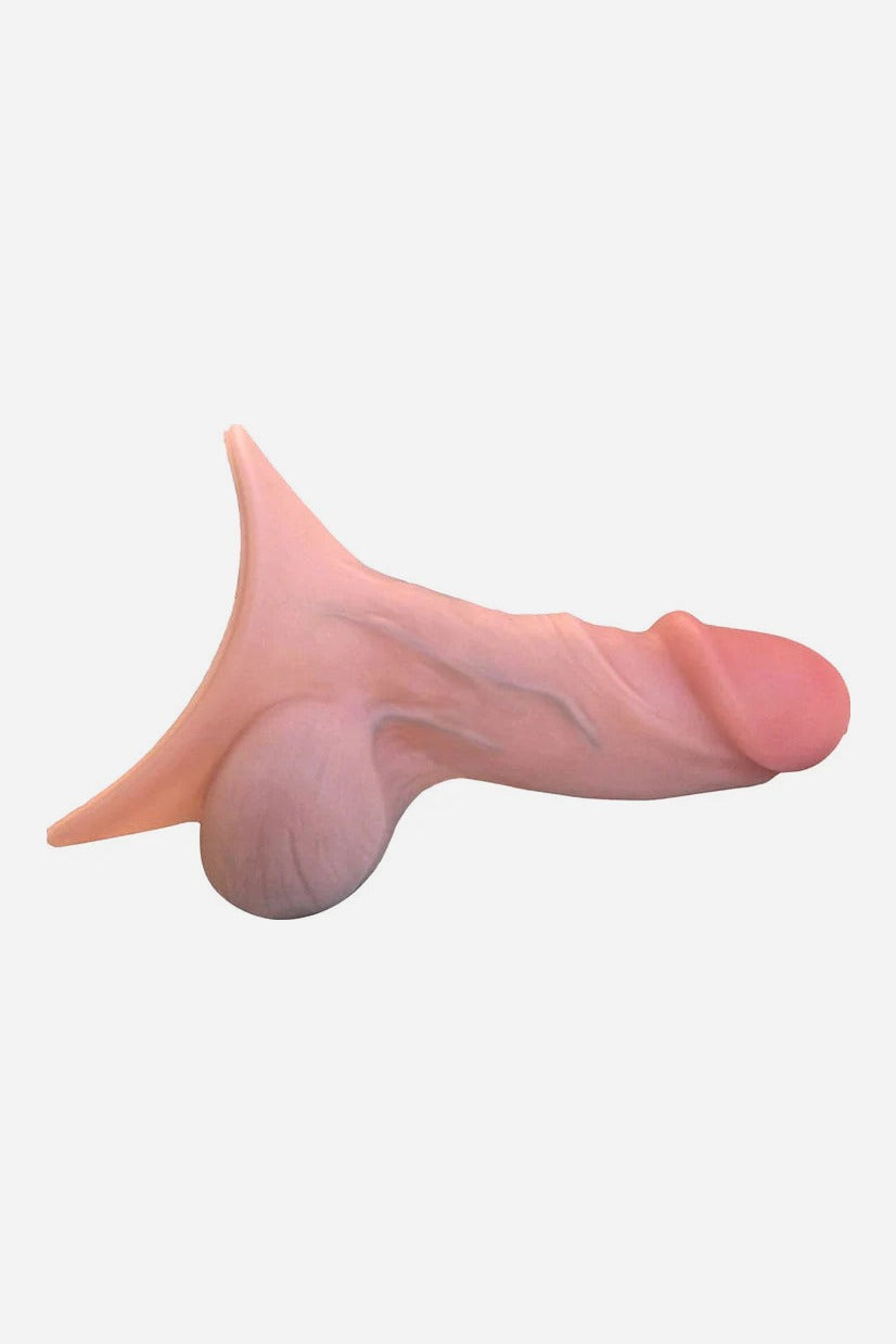 Side view of the Realistic 4.5 inch STP device in Vanilla, a light pink-toned silicone packer with veins and funnel base
