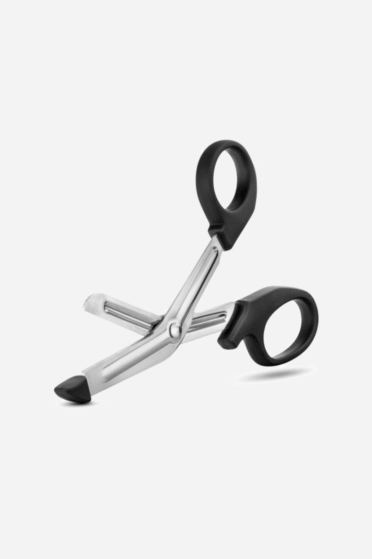 The safety scissors lying open at an angle, showing the two black finger loops and the curve of the stainless steel blade below
