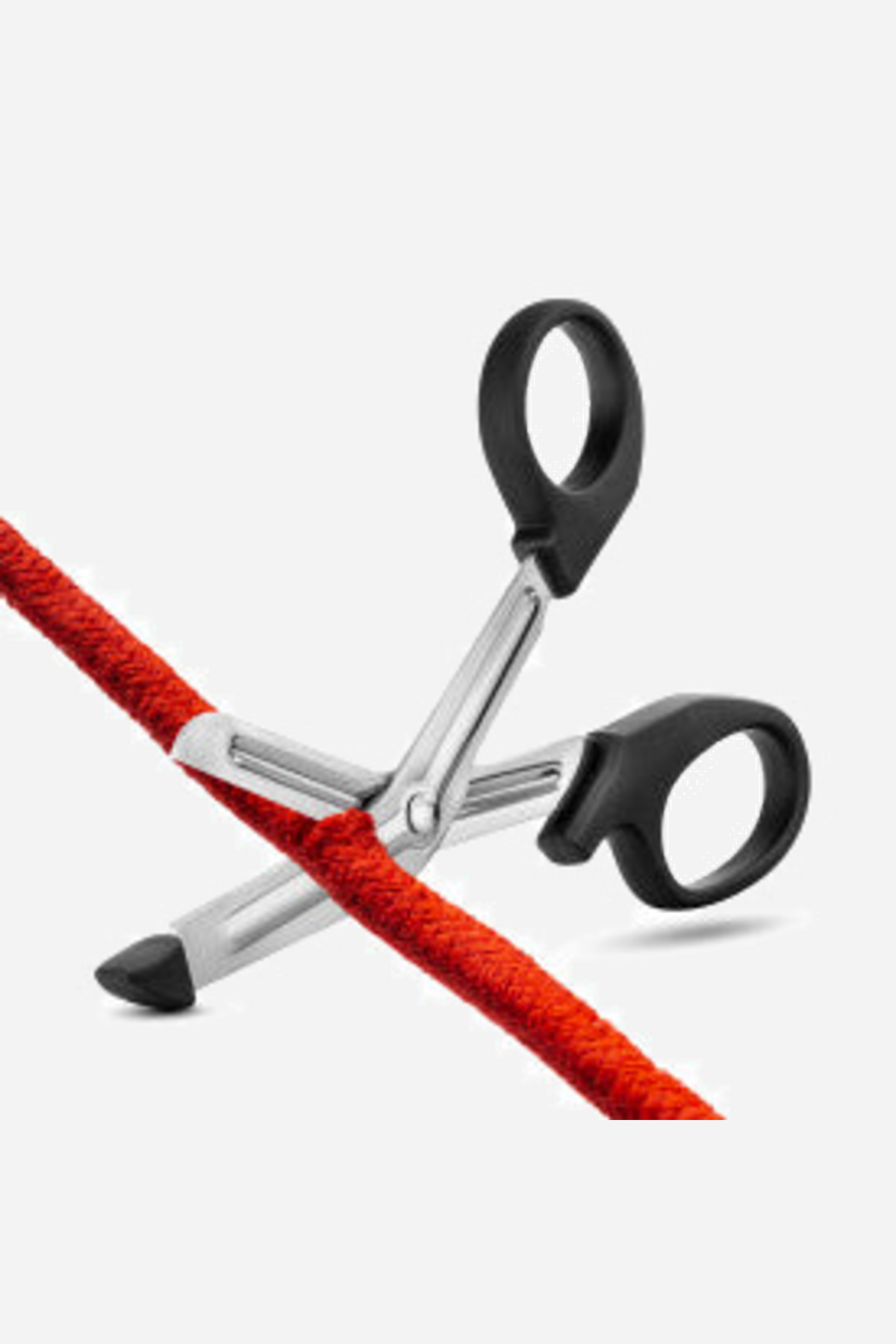 The safety scissors cutting through a length of red bondage rope, showing the blunt tip sliding safely underneath the rope itself