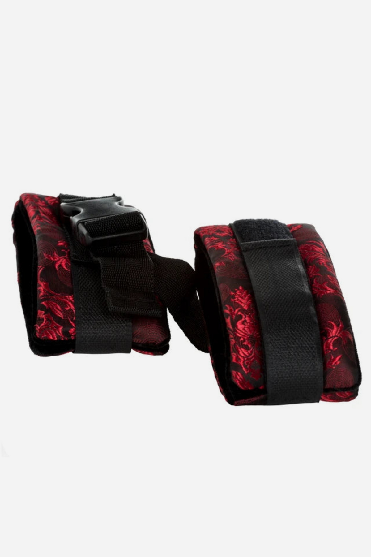 Close view of the Scandalous Brocade Cuffs showing the wide hook-and-loop closures, red brocade outer layer and the connecting buckle