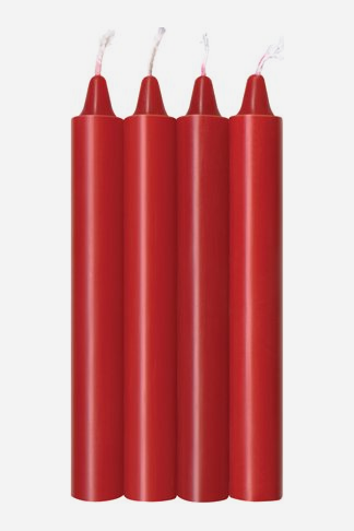 Set of four tall red taper wax play candles in matching shades of red, standing side by side with their white wicks showing