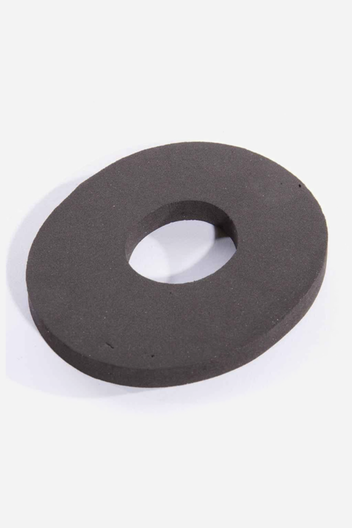 The larger stabilizer ring seen from a lower angle, showing the wider central opening and the smooth matte surface of the rubber.