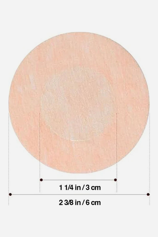 Dimension diagram of a round fabric nipple cover: 2 3/8 inch (6 cm) overall diameter with a 1 1/4 inch (3 cm) non-adhesive centre