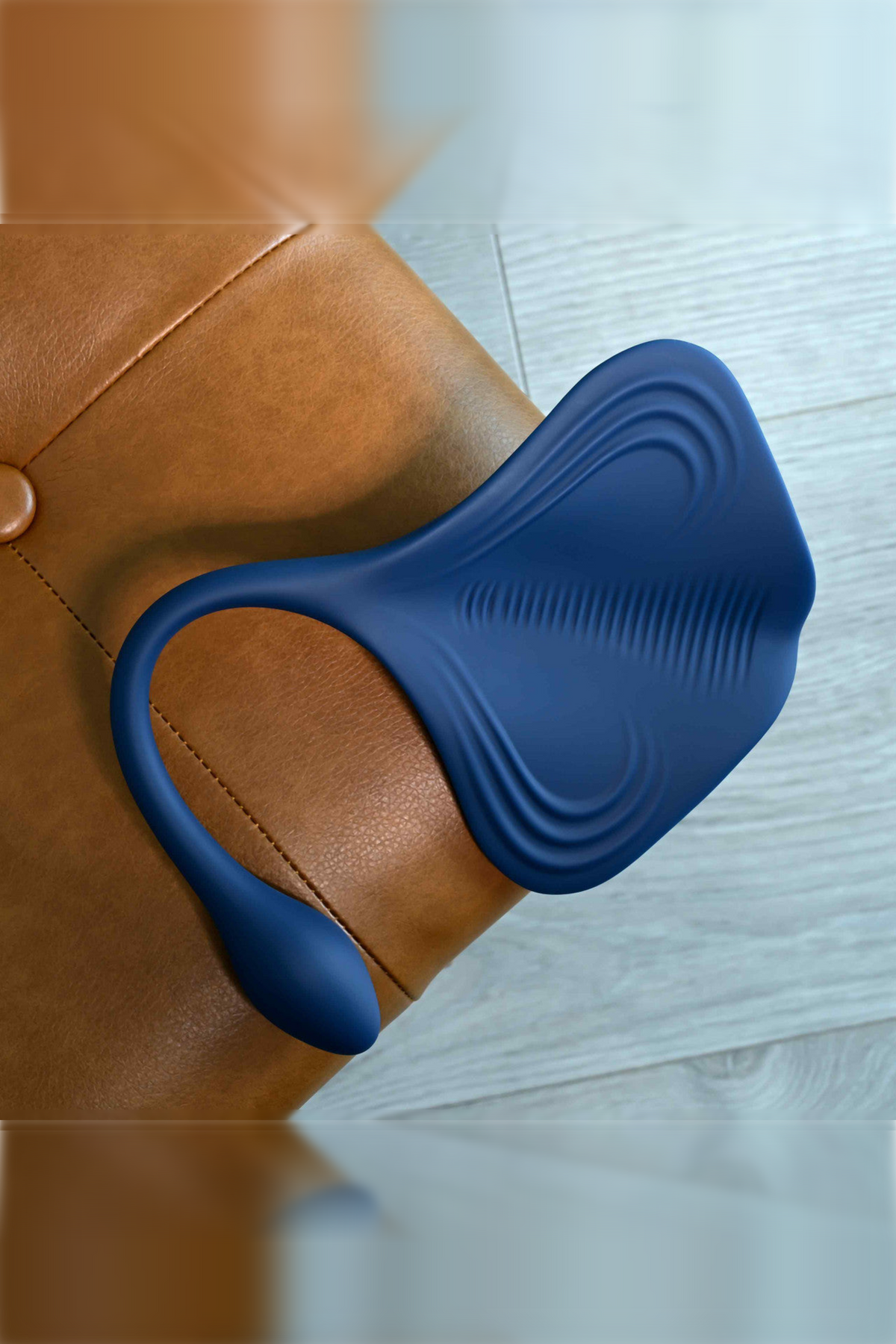 Overhead close-up of The Daily Grind pad showing the concentric silicone ridges on its grinding surface and the bulbous plug tip