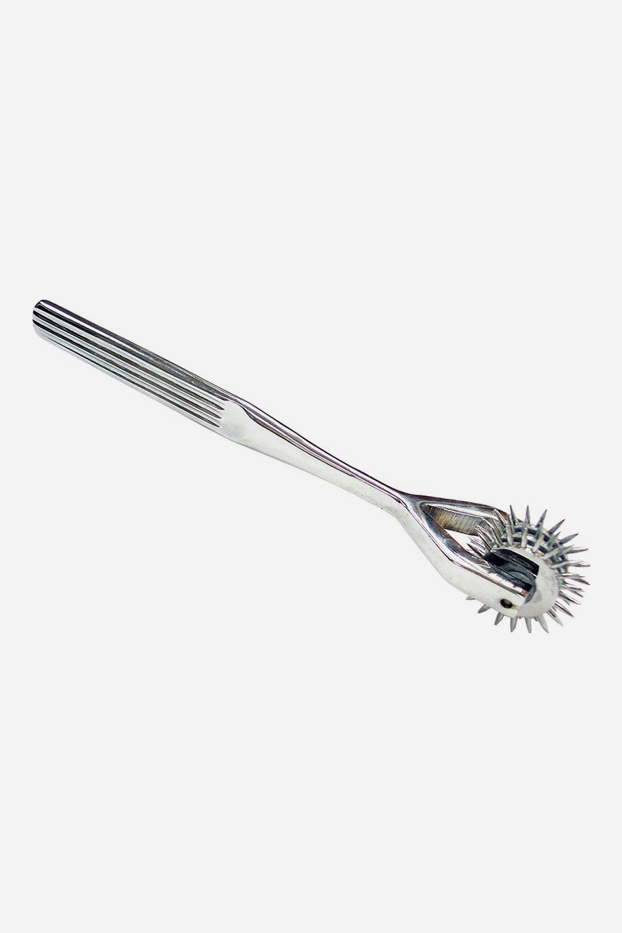 Chrome Wartenberg sensation pinwheel with a ridged metal handle and three rows of spiked wheels at the tip, used for light sensation play