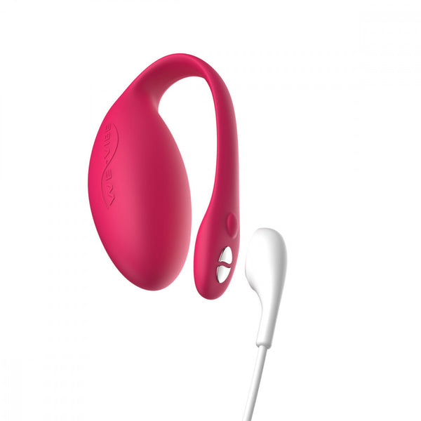 wearable panty vibe, an egg shaped pink We-Vibe Jive with the magnetic charging cord close to the toy, showing the toy is rechargeable. 
