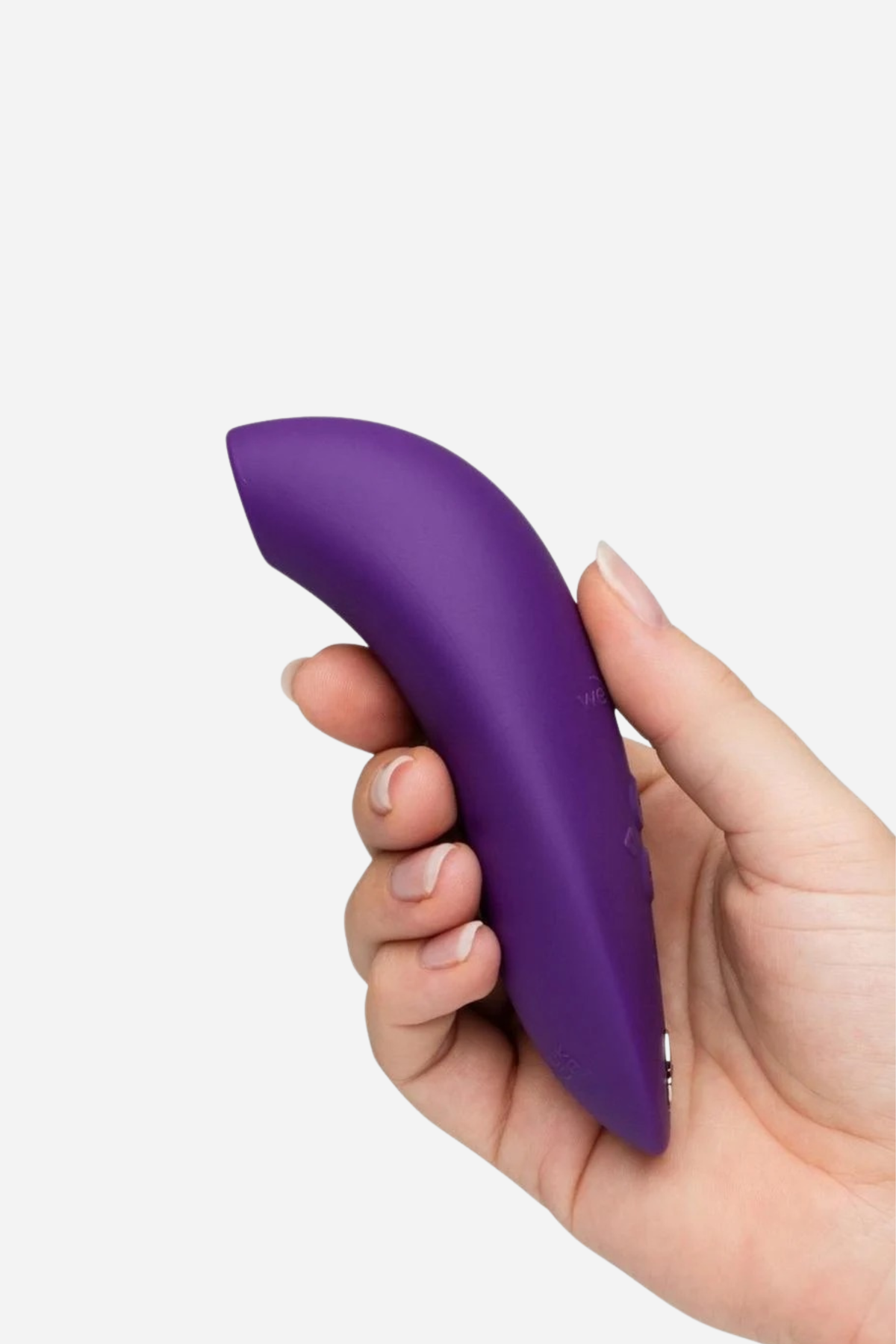 We-Vibe Melt 2 suction toy in Purple held in a hand, showing the curved body and soft suction opening at the tip on light grey
