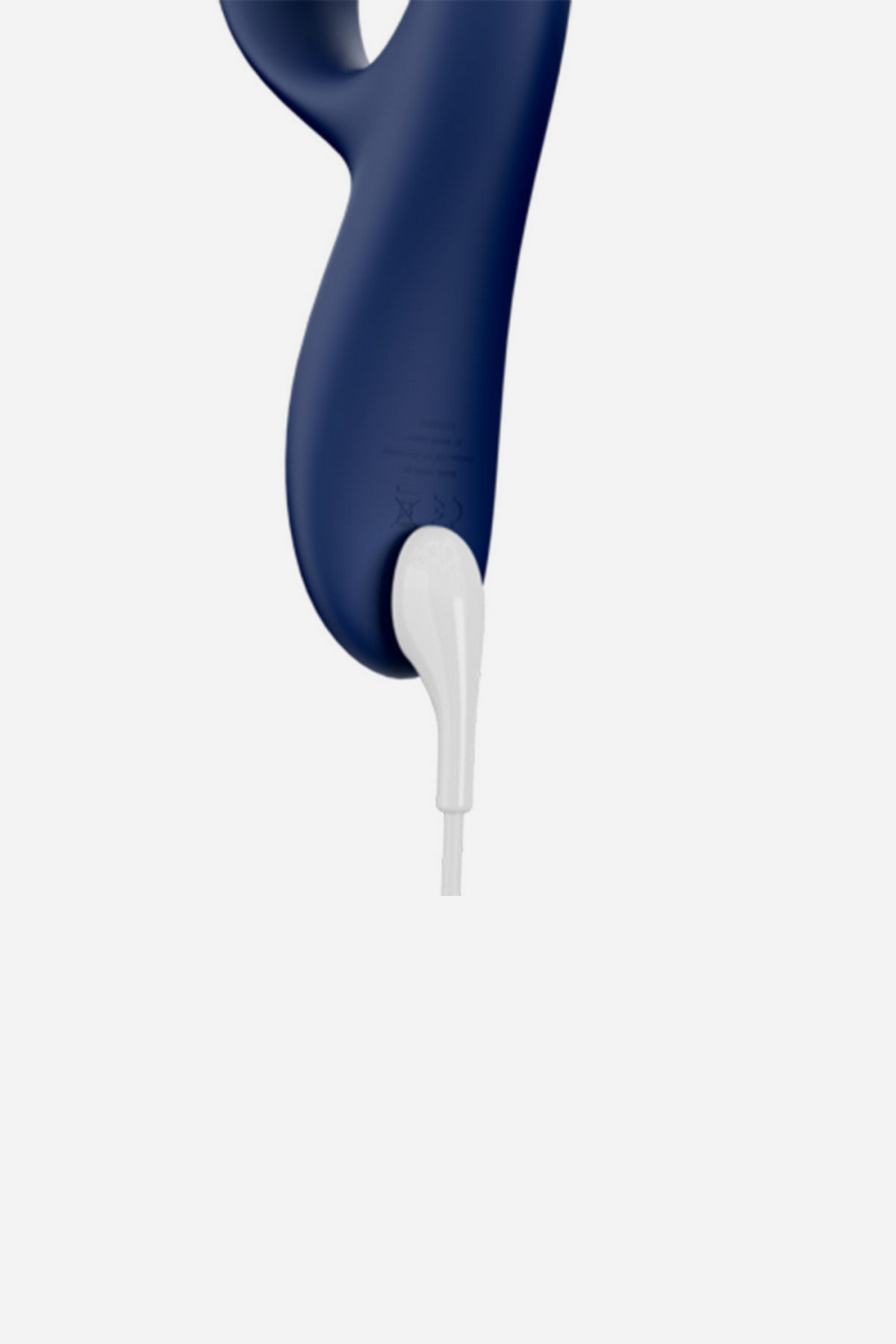 Midnight blue We-Vibe Nova 2 Rabbit Vibe attached to its magnetic USB charging cable, shown close up at the base of the handle